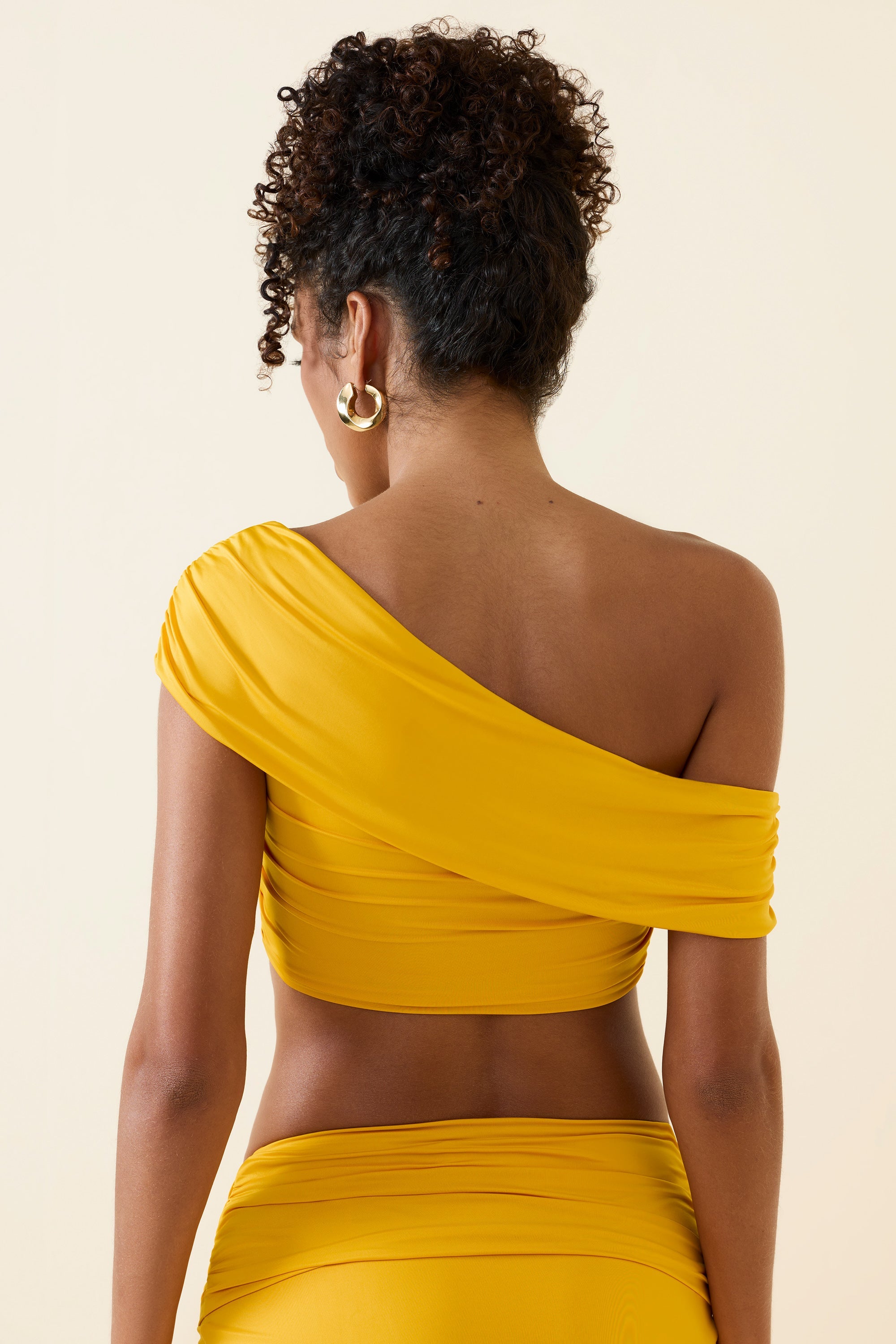Inga Asymmetric Ruched Off-Shoulder Crop Top in Golden Yellow - Image 2