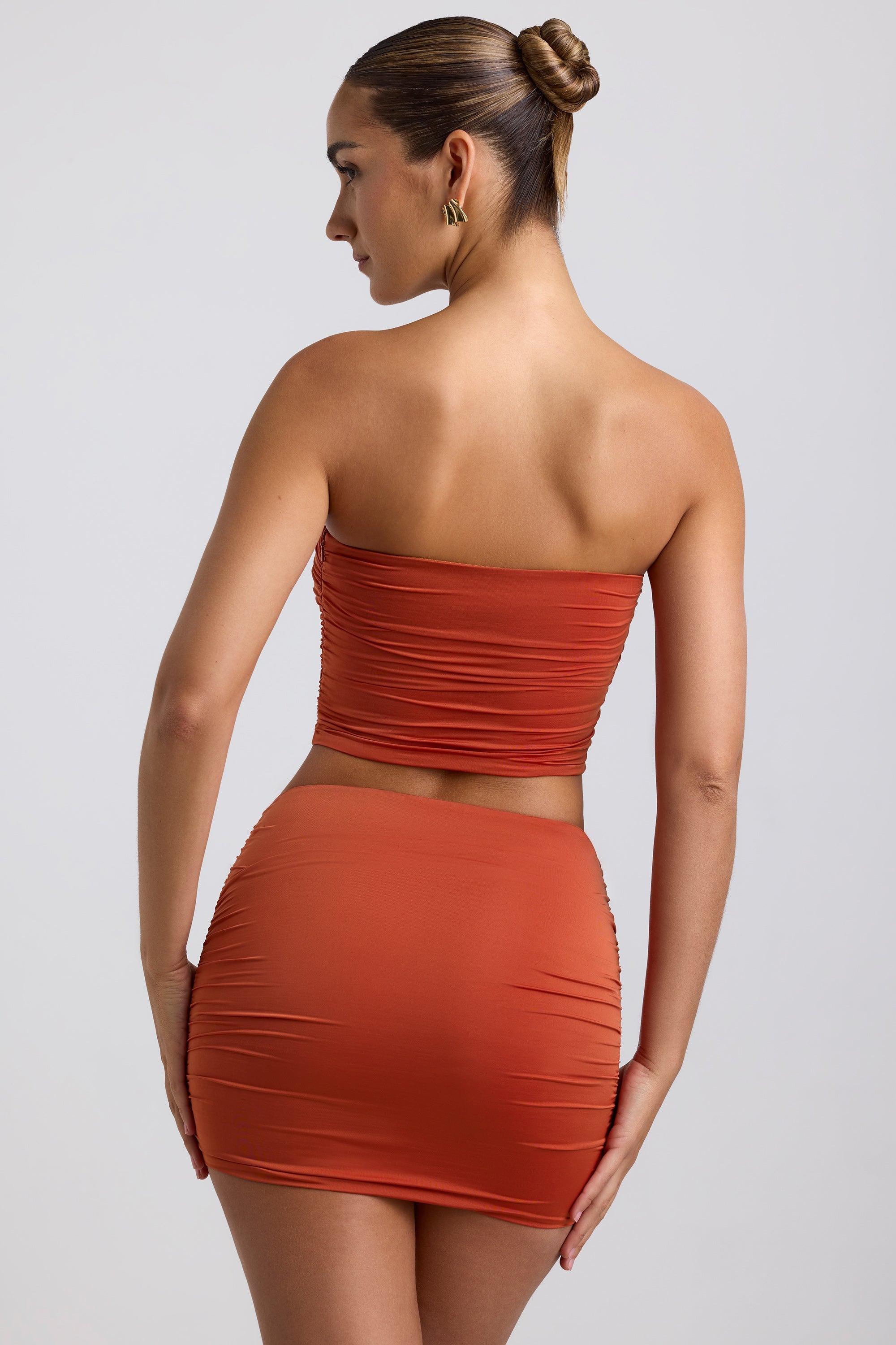 Morowa Slinky Jersey Ruched Hardware Detail Strapless Top in Burnt Orange - Image 2