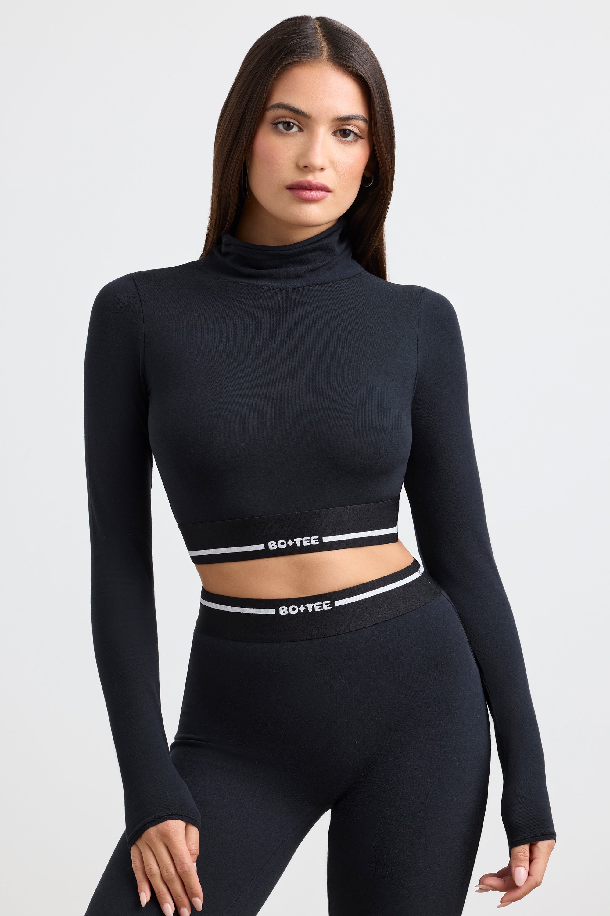 Grounded Turtleneck Backless Long-Sleeve Crop Top in Black