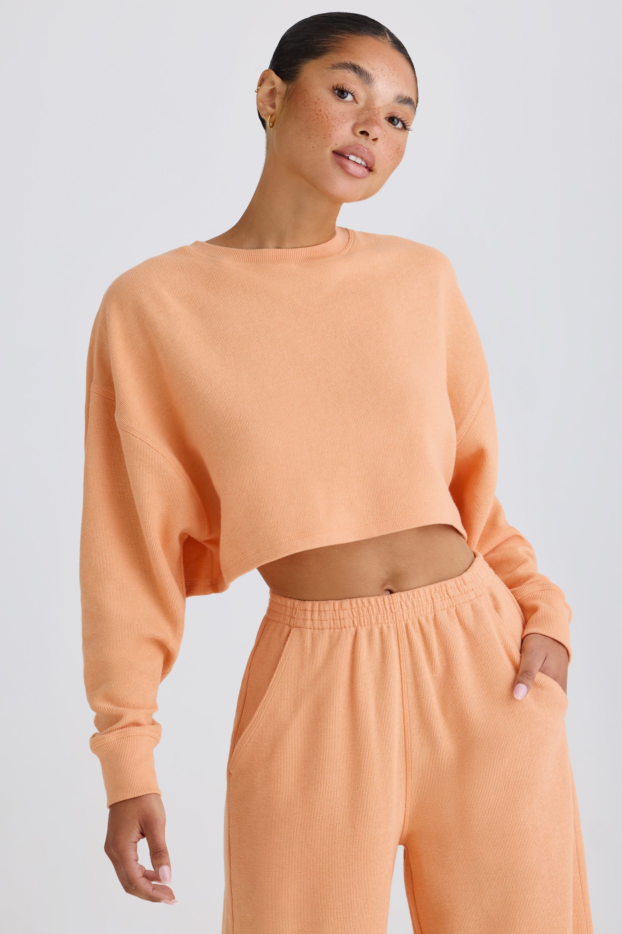 Jet Set Crew-Neck Open-Back Cropped Sweatshirt in Peach - Image 2