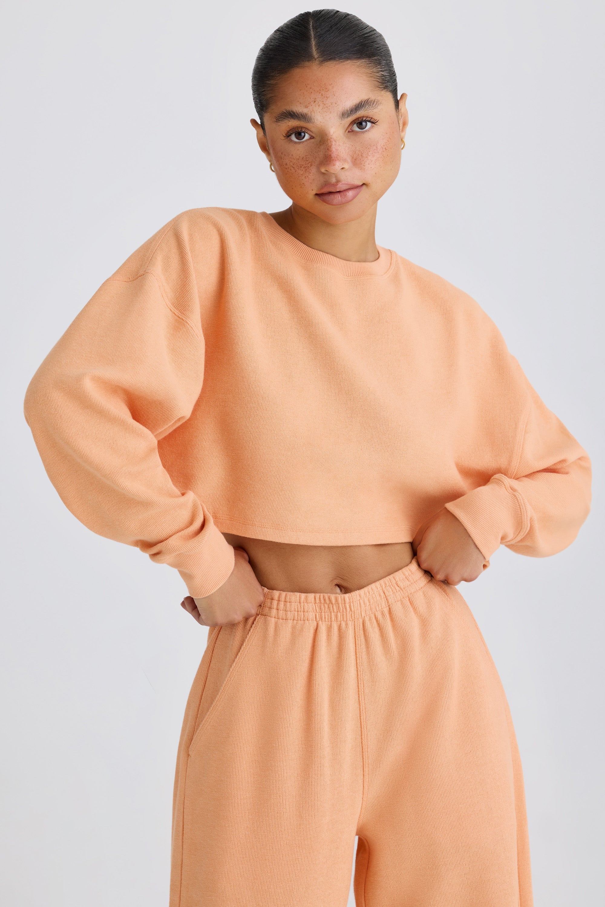 Jet Set Crew-Neck Open-Back Cropped Sweatshirt in Peach - Image 5
