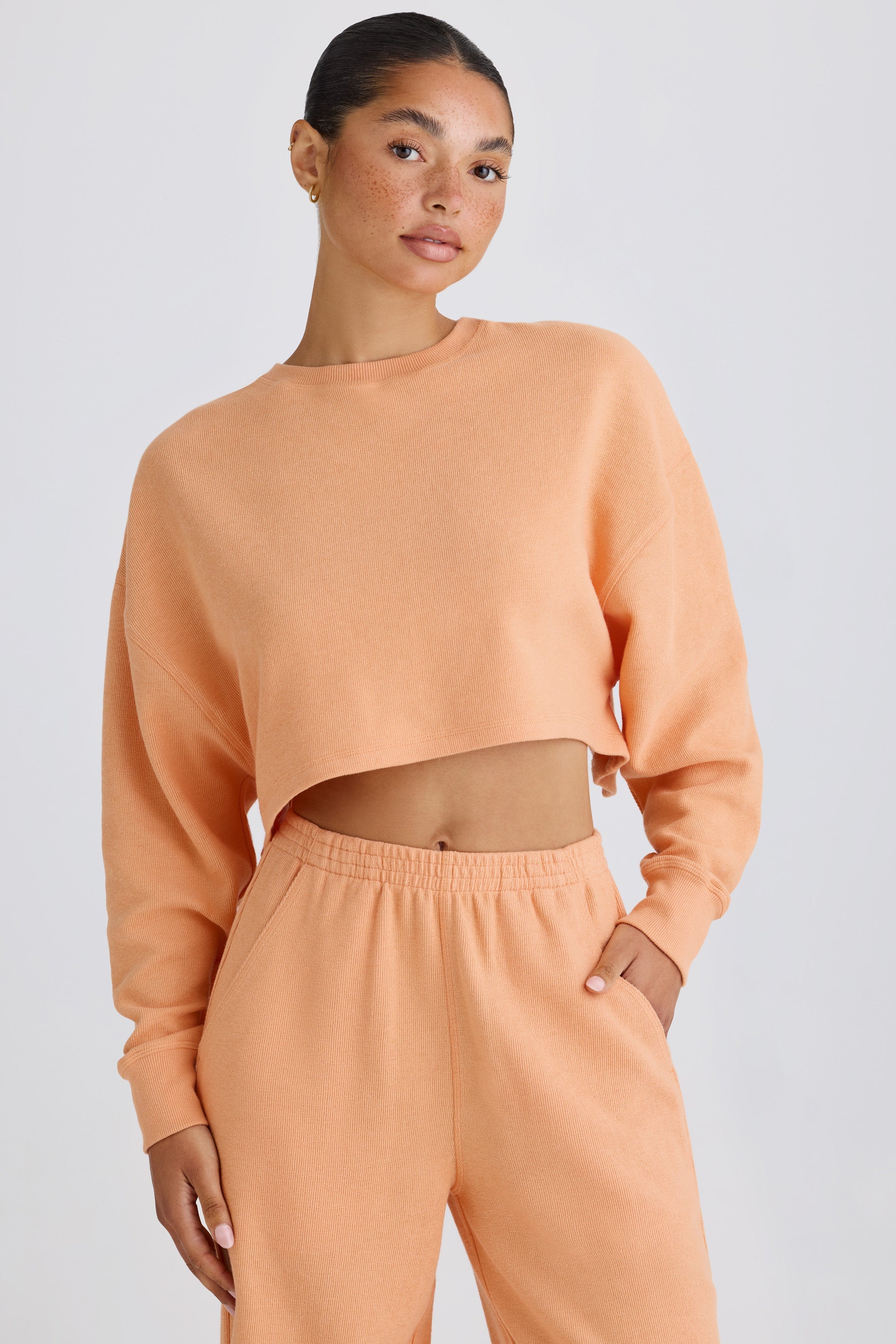 Jet Set Crew-Neck Open-Back Cropped Sweatshirt in Peach - Image 6