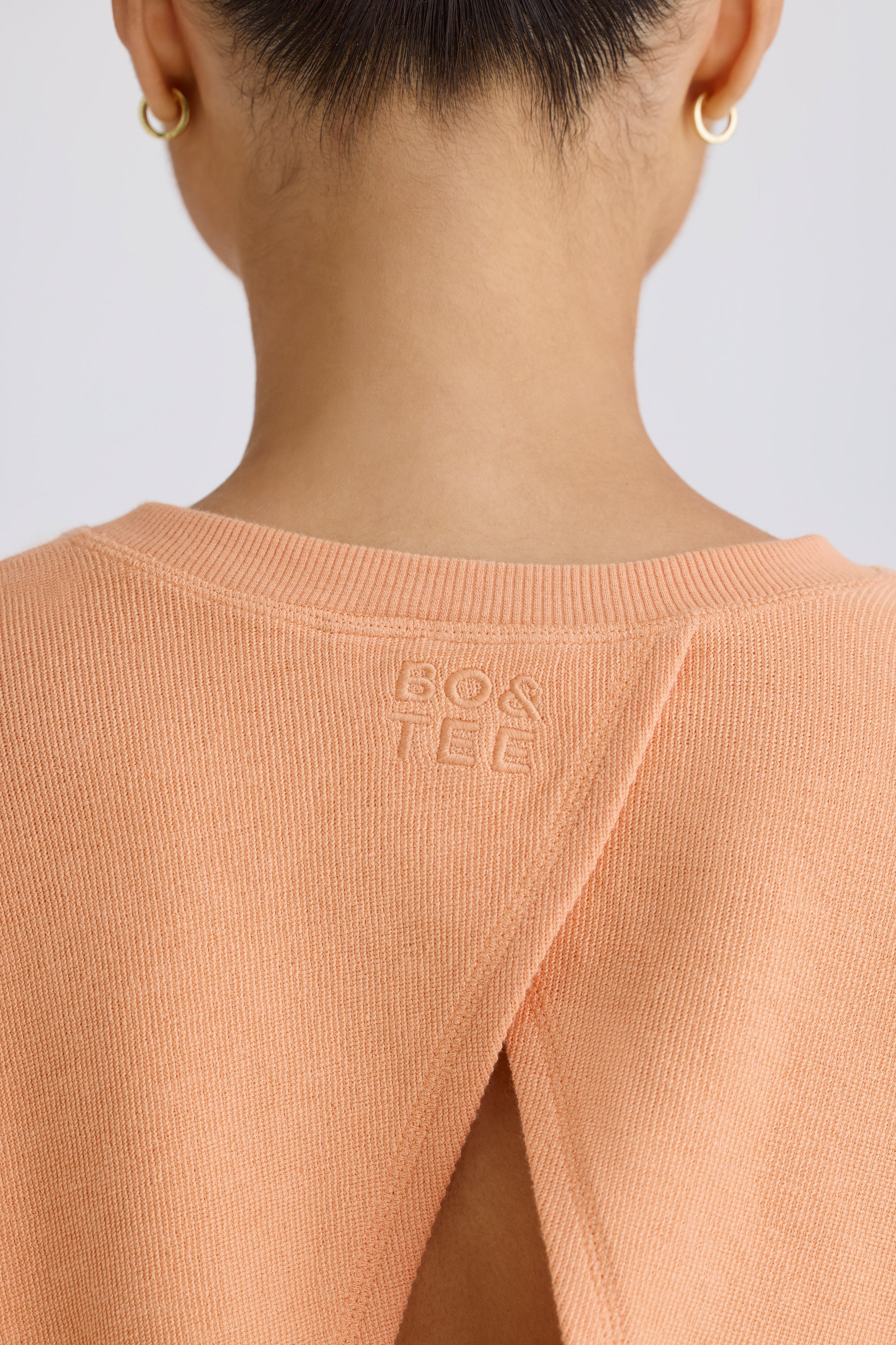 Jet Set Crew-Neck Open-Back Cropped Sweatshirt in Peach - Image 4